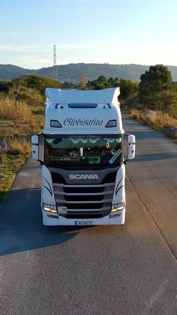 White tractor unit with Globisafira lettering on a country road